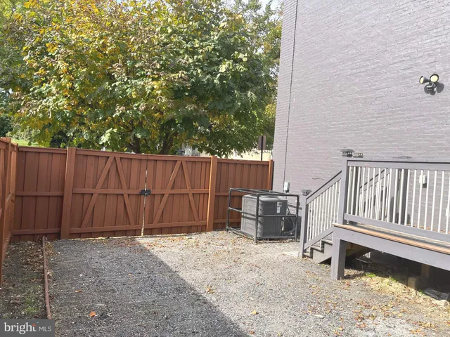 a view of a backyard with wooden fence