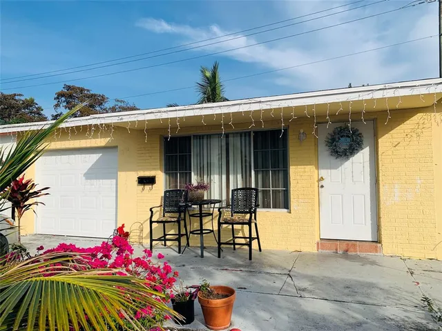 a front view of a house with outdoor seating