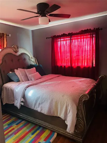 a bed sitting in a bedroom next to a window