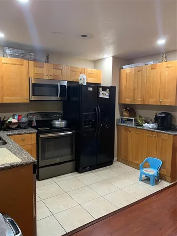a kitchen with stainless steel appliances a stove a refrigerator and a sink