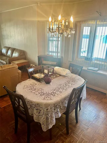a dining table with chairs and window