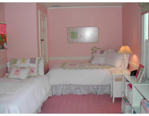 15 Old Colony Road Wellesley, MA 02481 - Photo 11 of 15 a bedroom with a bed and a chandelier