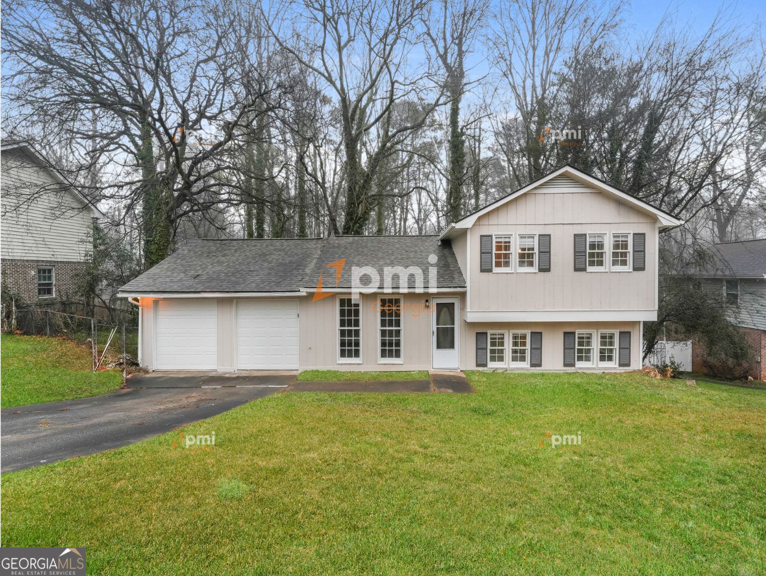 667 Rae Drive Southwest Lawrenceville, GA 30044 - Photo 1 of 19 a front view of a house with a garden and trees