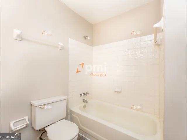 a bathroom with a toilet and a bathtub