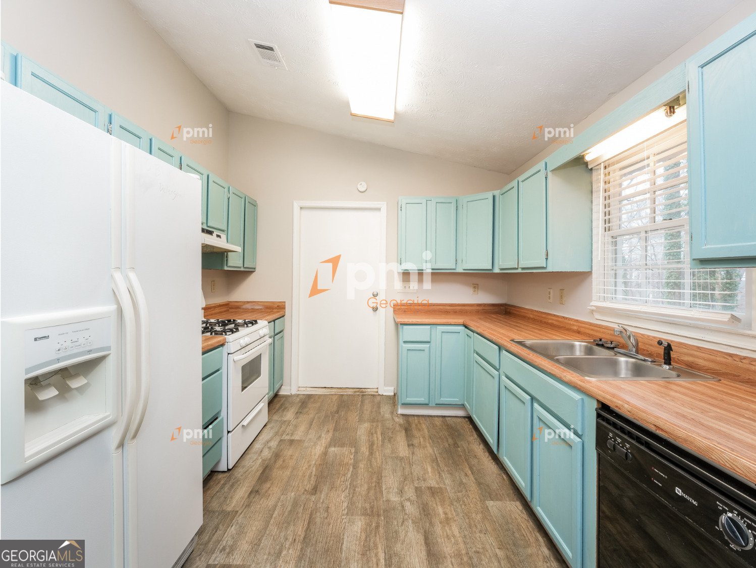 667 Rae Drive Southwest Lawrenceville, GA 30044 - Photo 2 of 19 a kitchen with granite countertop a sink a counter space appliances and cabinets