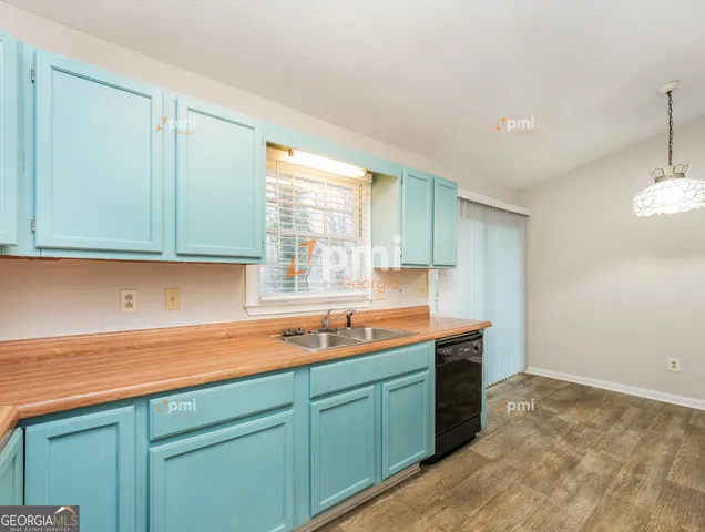a kitchen with stainless steel appliances granite countertop a sink and a stove