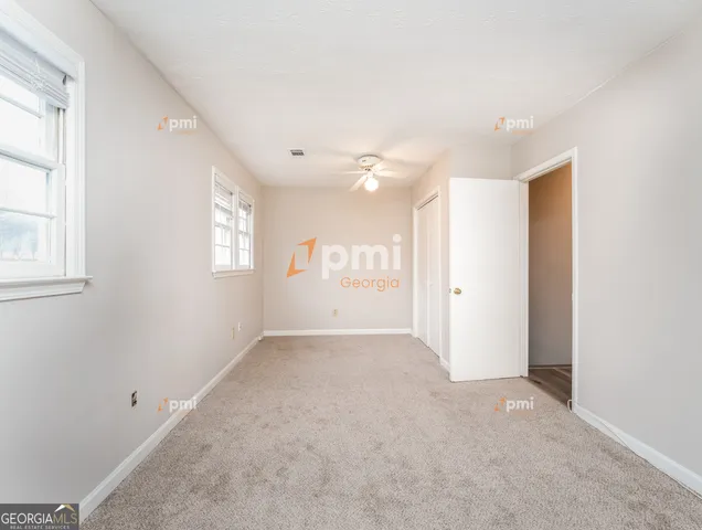 an empty room with windows and closet