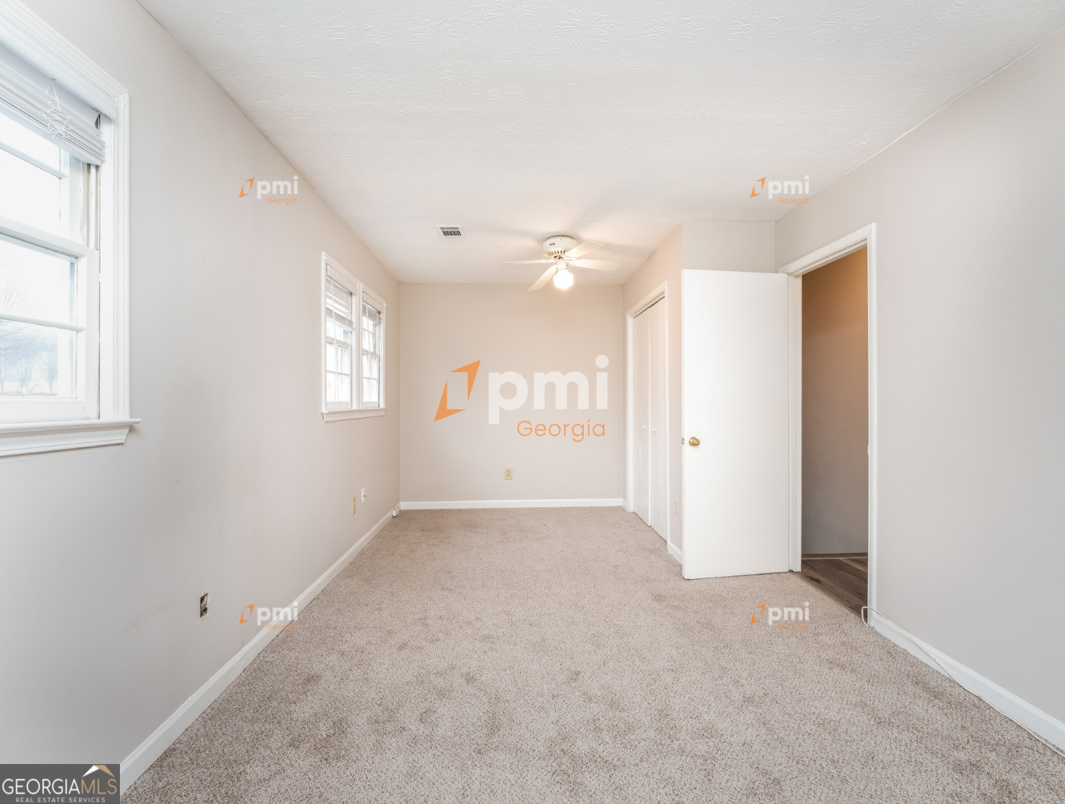 667 Rae Drive Southwest Lawrenceville, GA 30044 - Photo 9 of 19 an empty room with windows and closet