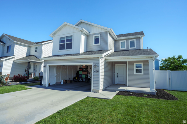 1486 West 2055th Street South Logan, UT 84339 - Photo 4 of 45 Two-story residence featuring light gray siding, an attached garage, and a covered entry porch