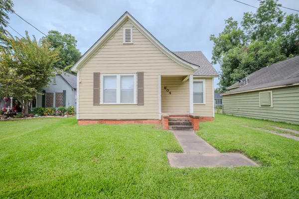 a front view of a house with a yard