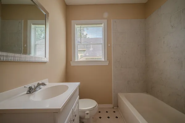 a bathroom with a sink toilet and bathtub