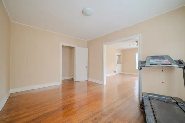 a view of a room with wooden floor