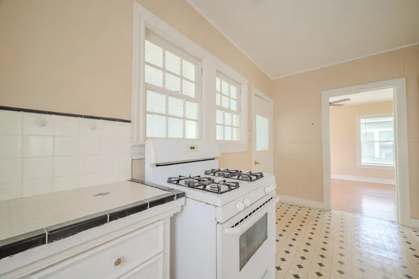 a kitchen that has a stove and a granite counter tops