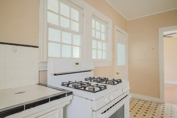 a kitchen with a stove and a refrigerator