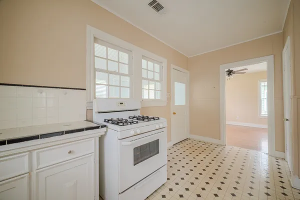 a kitchen with a stove a sink and a refrigerator