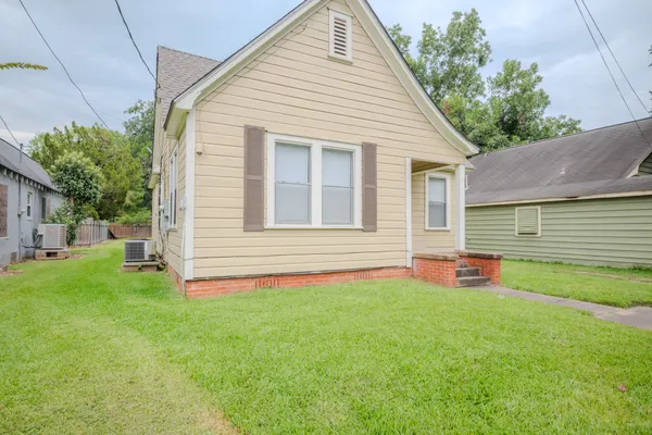 a backyard of a house with table and chairs