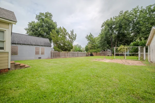 a view of a house with backyard and a small cabin
