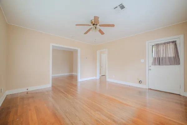 wooden floor in an empty room with a window