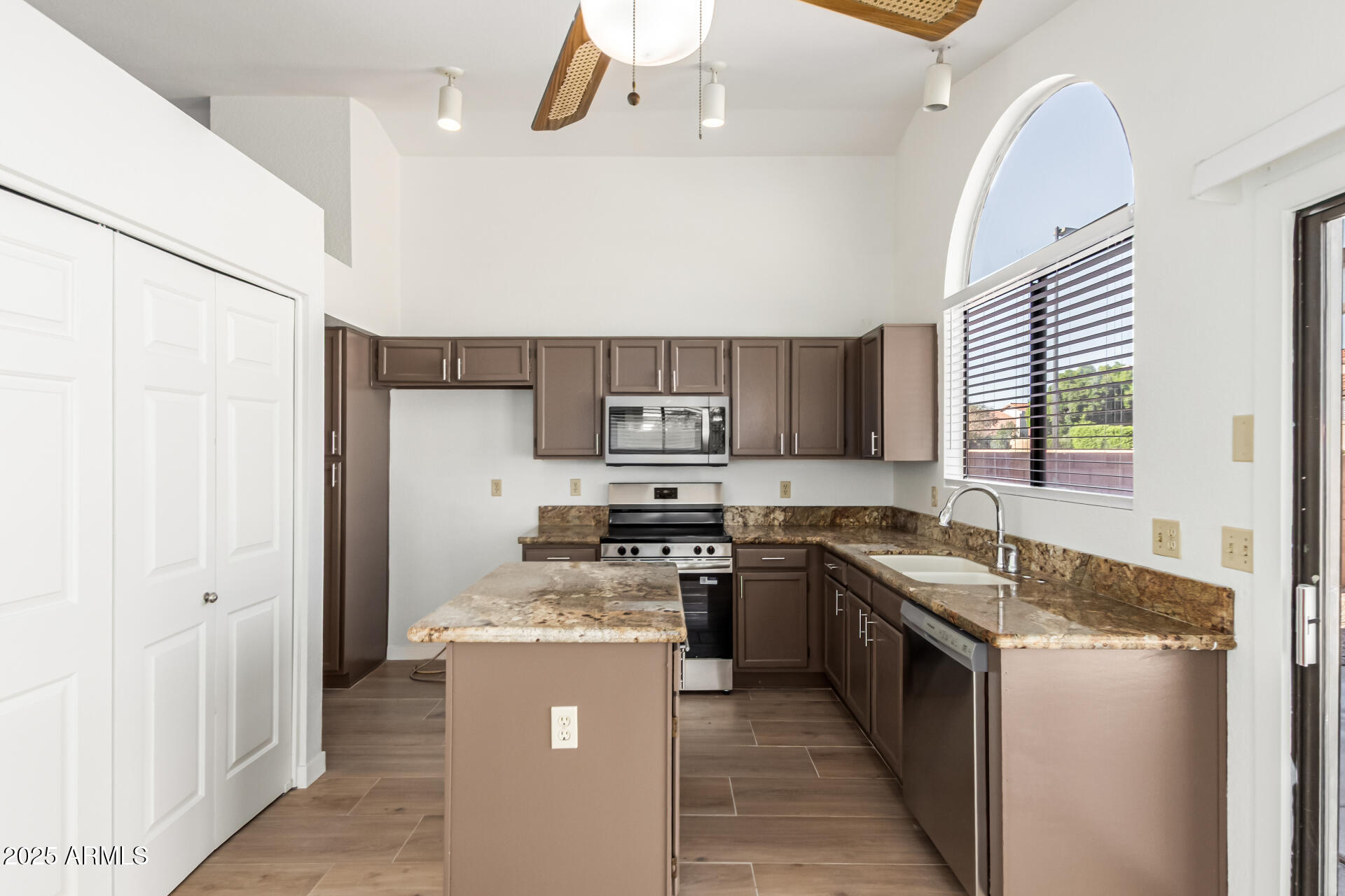 768 South Martinique Drive Gilbert, AZ 85233 - Photo 11 of 27 a kitchen with a stove sink and a refrigerator