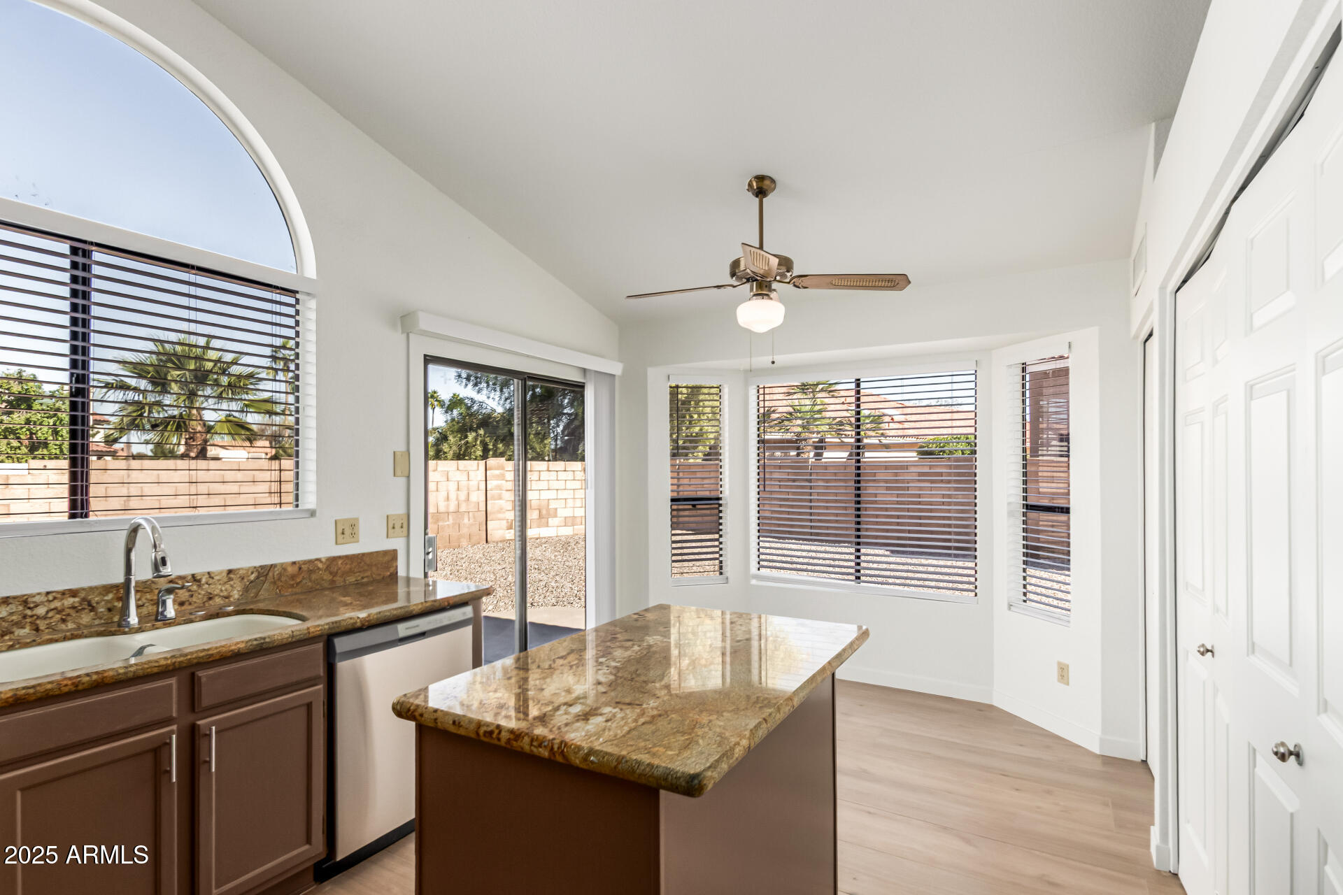 768 South Martinique Drive Gilbert, AZ 85233 - Photo 13 of 27 a kitchen with granite countertop a sink and dishwasher with wooden floor