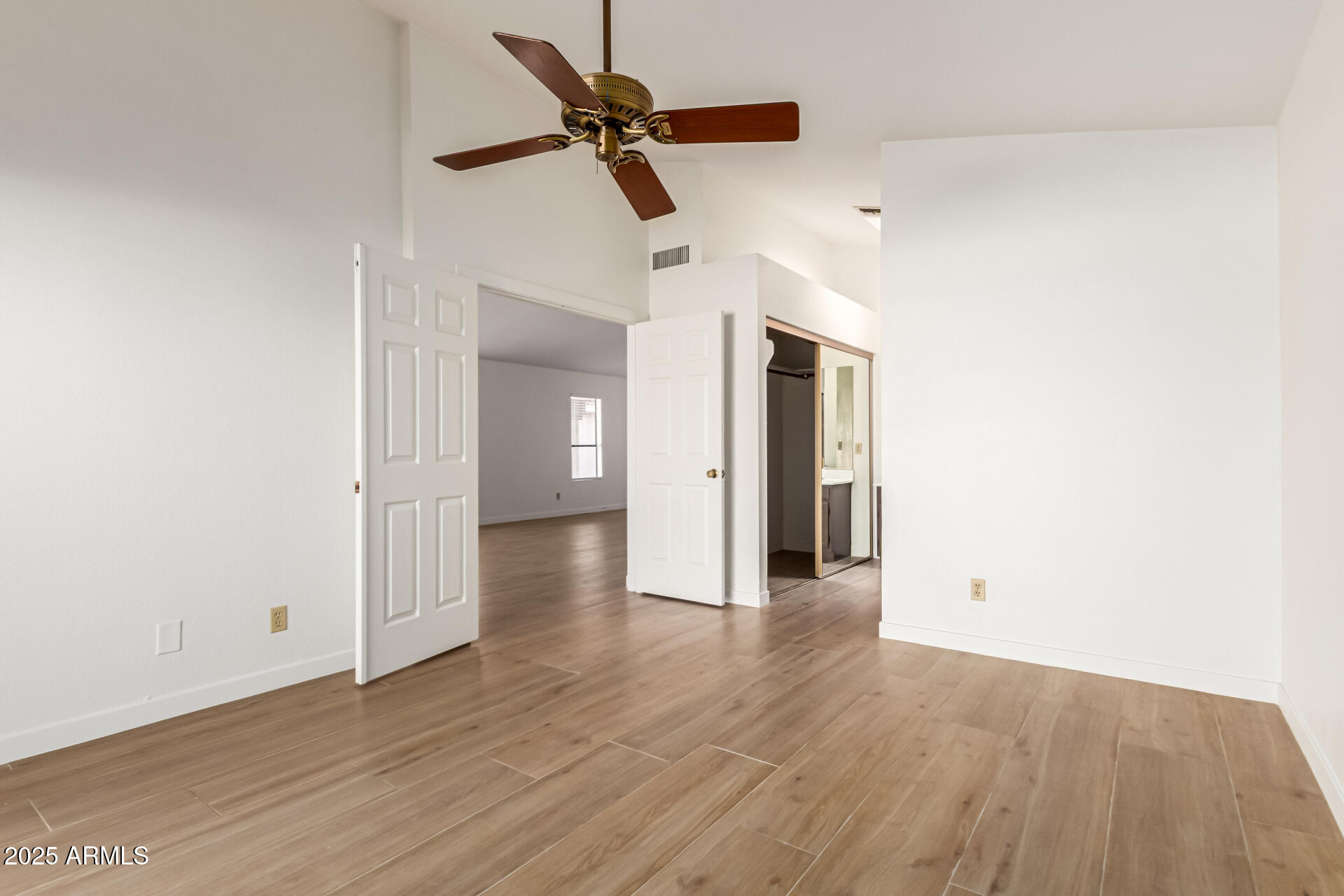 768 South Martinique Drive Gilbert, AZ 85233 - Photo 15 of 27 a view of a livingroom with a ceiling fan & wooden floor