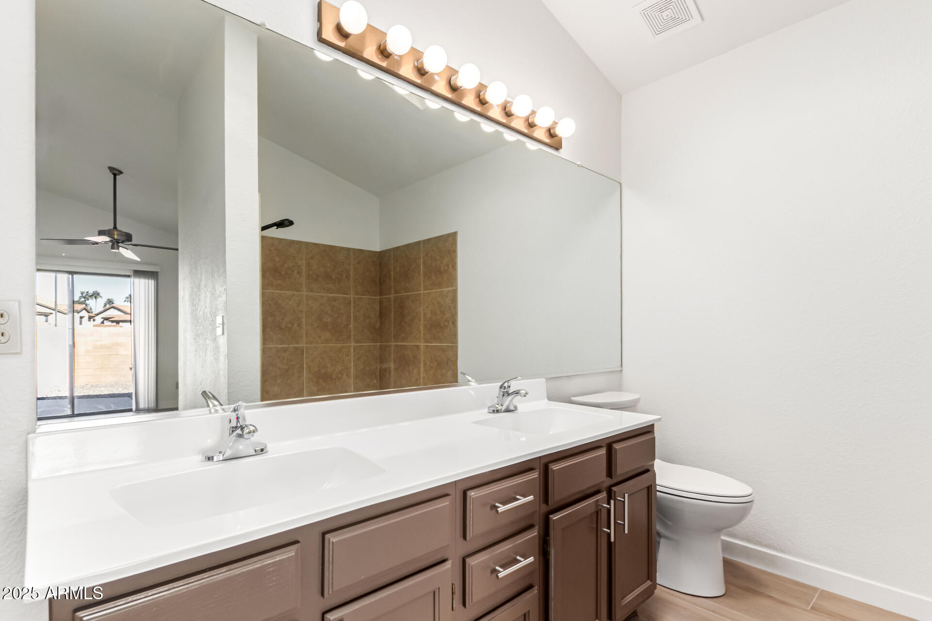 768 South Martinique Drive Gilbert, AZ 85233 - Photo 17 of 27 a bathroom with a sink and a large mirror