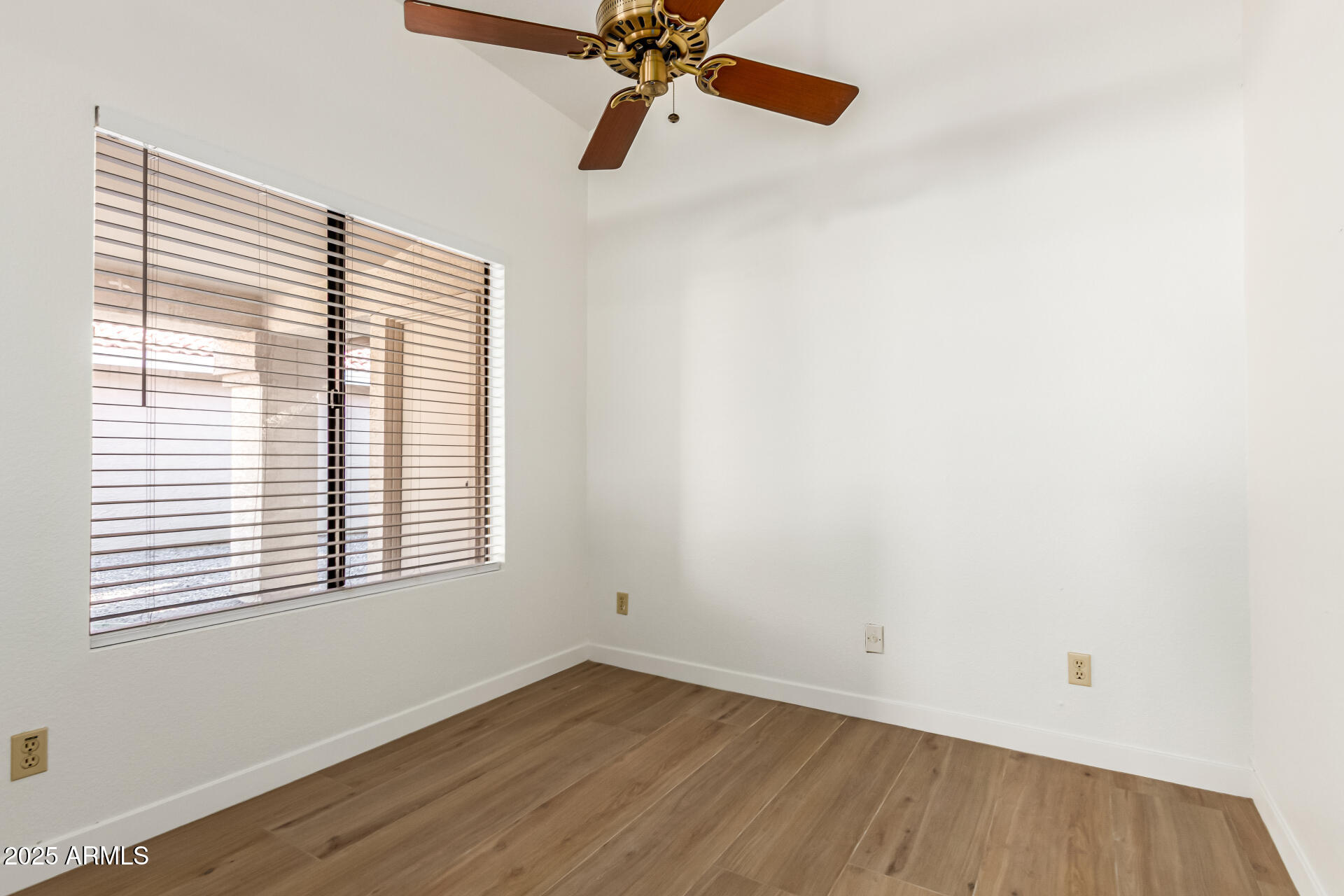 768 South Martinique Drive Gilbert, AZ 85233 - Photo 7 of 27 an empty room with a window and a ceiling fan