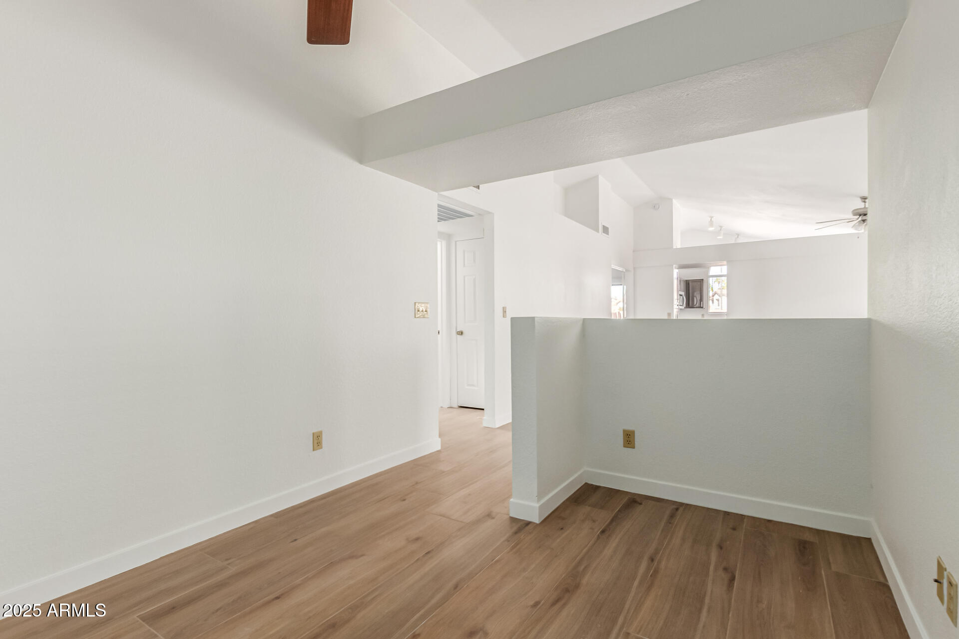 768 South Martinique Drive Gilbert, AZ 85233 - Photo 8 of 27 an empty room with wooden floor and windows