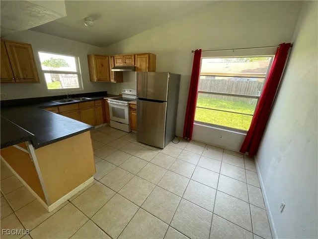 a kitchen with a refrigerator and window