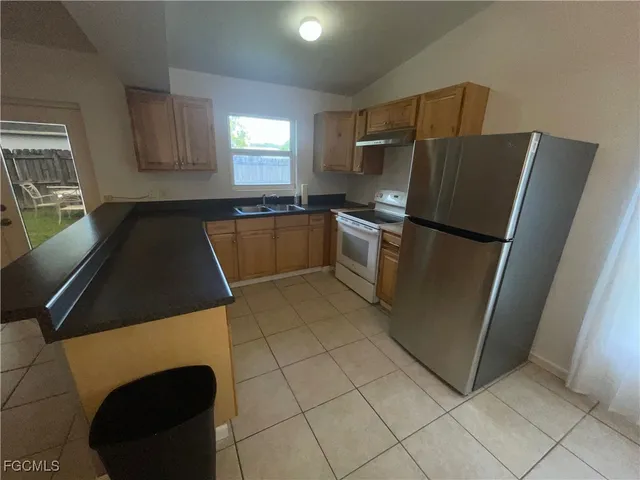 a kitchen with a refrigerator and a stove