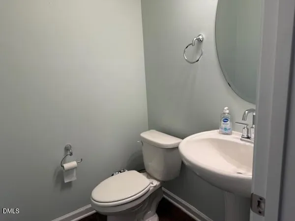 a white toilet sitting next to a bathroom sink