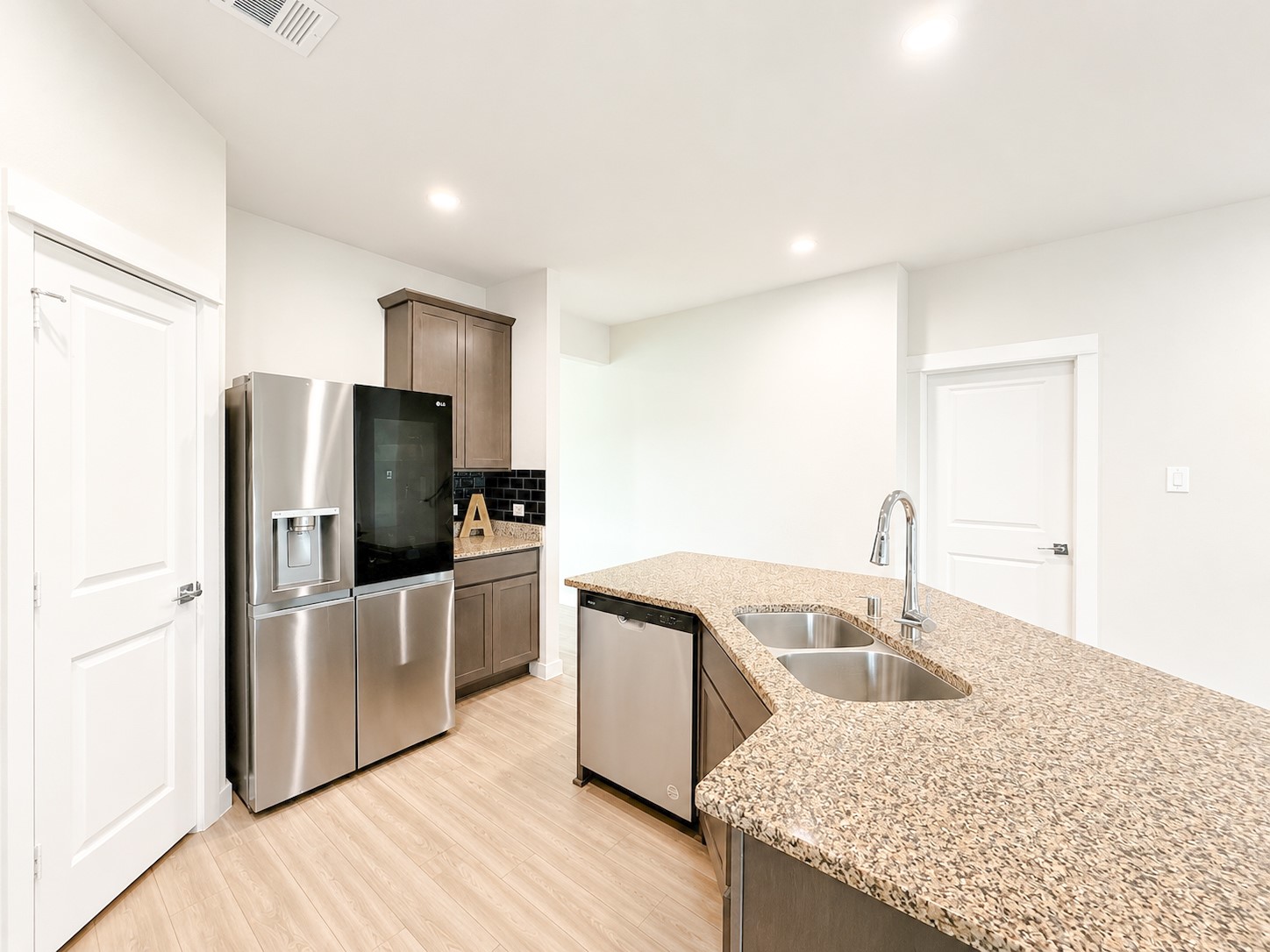 323 Bennett Street Angleton, TX 77515 - Photo 4 of 21 a kitchen with kitchen island a sink appliances and cabinets