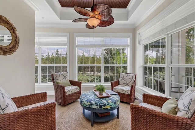 a living room with furniture a flat screen tv and a large window