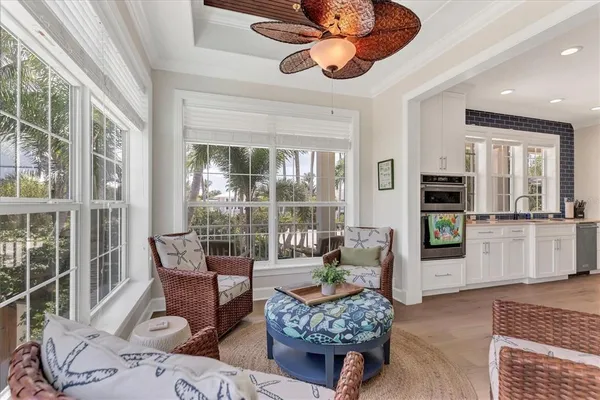 a living room with furniture fireplace and a large window