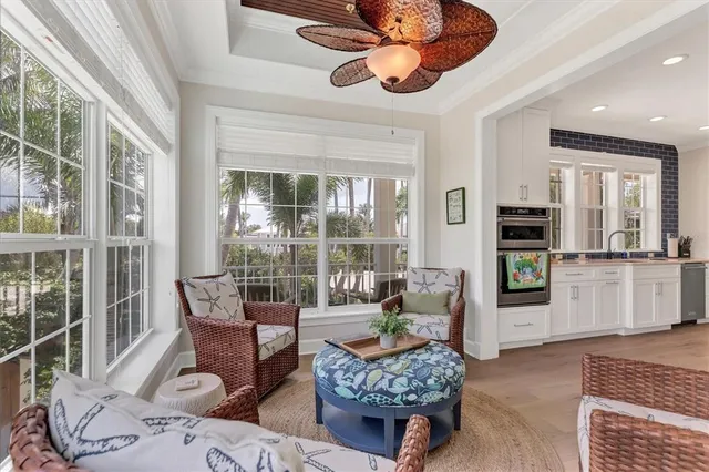 a living room with furniture fireplace and a large window