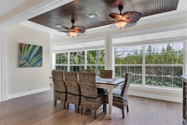 a living room with furniture kitchen view and a large window