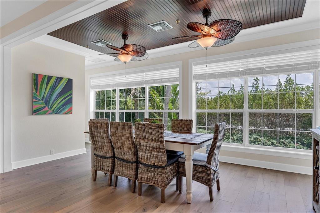 2425 24th Street West Boca Grande, FL 33921 - Photo 25 of 53 a dining room with furniture a chandelier and wooden floor