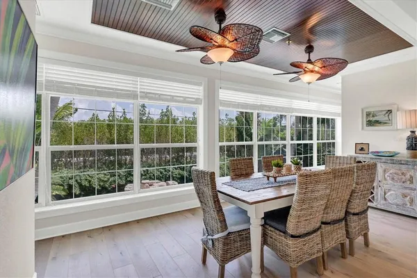 a kitchen with stainless steel appliances granite countertop a table chairs stove and refrigerator