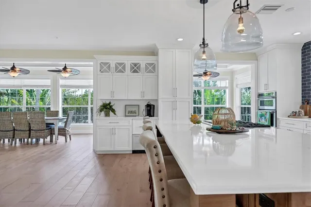 a kitchen with a stove and a view of living room