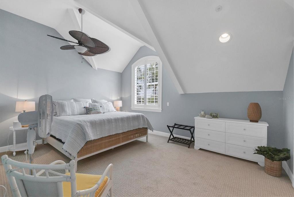 2425 24th Street West Boca Grande, FL 33921 - Photo 38 of 53 a bedroom with a bed and a chandelier