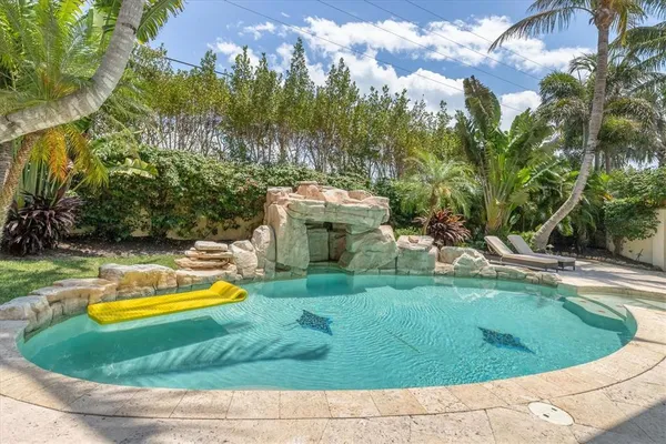 a view of a backyard with plants and outdoor seating