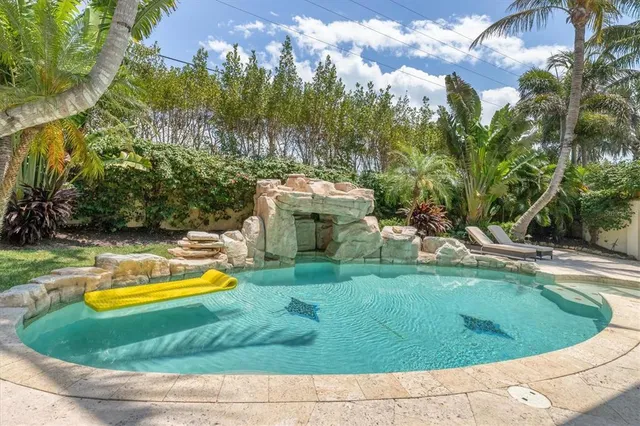 a view of a backyard with plants and outdoor seating