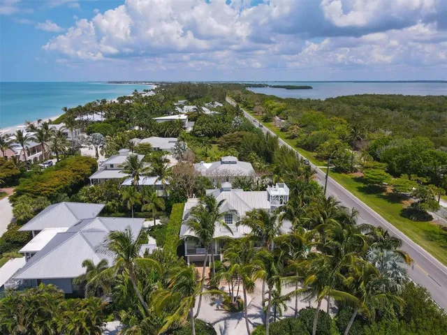 front view of a house with a yard and potted plants