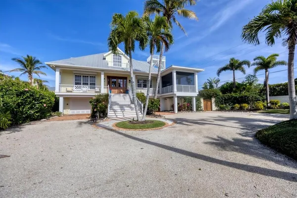 a front view of a house with a yard and a garage