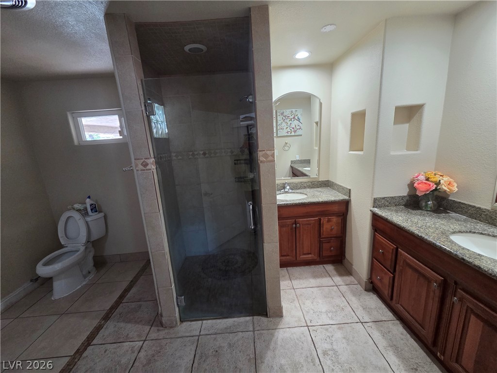 3381 Westwind Road Las Vegas, NV 89146 - Photo 24 of 52 Granite counters and tiled flooring enhance this well-appointed bathroom.