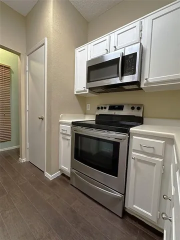 a kitchen with stainless steel appliances a stove a microwave and cabinets