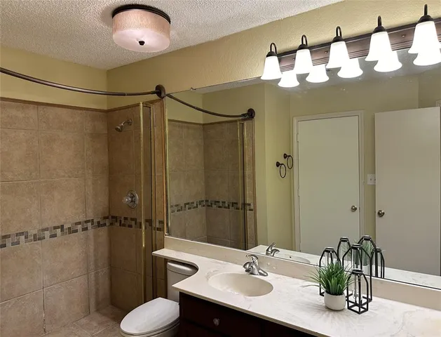 a bathroom with a sink toilet and shower