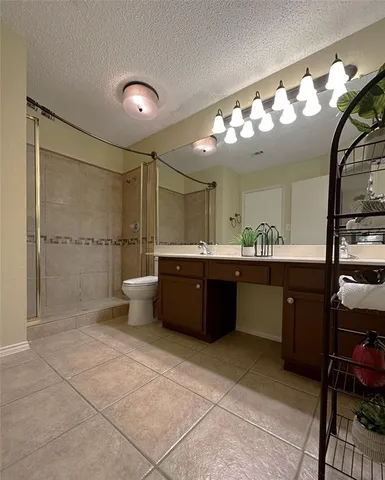 a bathroom with a sink mirror and a shower