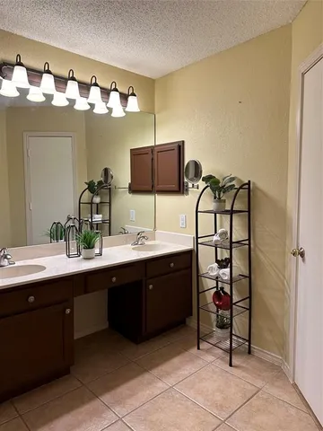 a spacious bathroom with a double vanity sink and a mirror