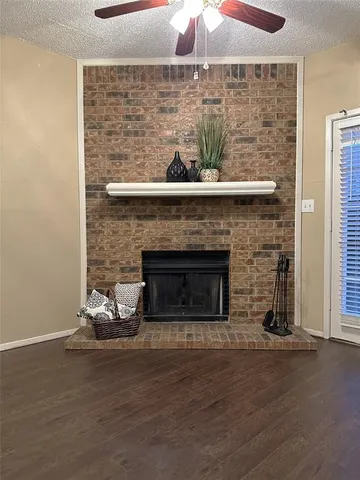 a room with a fireplace and a wooden floor